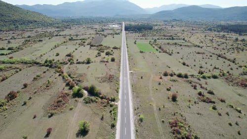 Empty Asphalt Road on the Plateau Between Green Fields Highland Way Aerial View