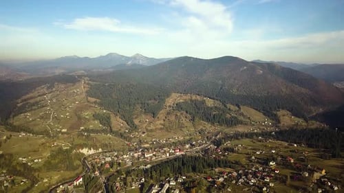 Luftaufnahme der herbstlichen Berglandschaft mit immergrünen Kiefern und gelbem Herbstwald mit