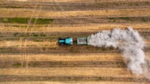 Tractor plowing dry field. Agriculture in Poland. Aerial view