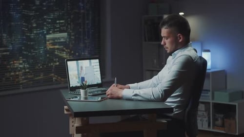 Man Participating in Video Call at Night