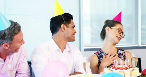 Colleagues Celebrating Birthday with Cake in Office