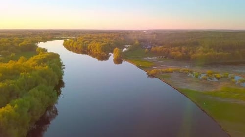 Beautiful View of the Picturesque Winding River Surrounded By Forest at Sunset
