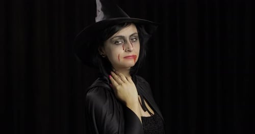 Vampire Halloween Makeup. Woman Portrait with Blood on Her Face.