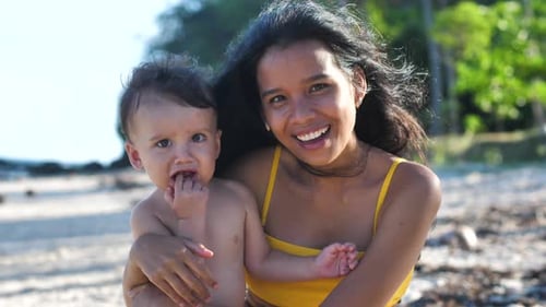Mother and Baby Laughing on Tropical Beach