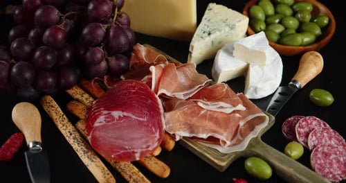 Antipasto with Grapes and Olives on the Table.