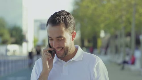 Man Celebrates Good News on Cell Phone Outdoors