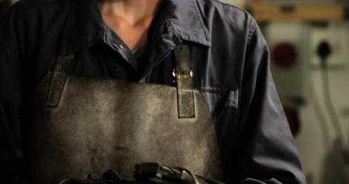 Female welder holding wrench tool