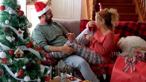 Couple Laughing and Celebrating Christmas at Home