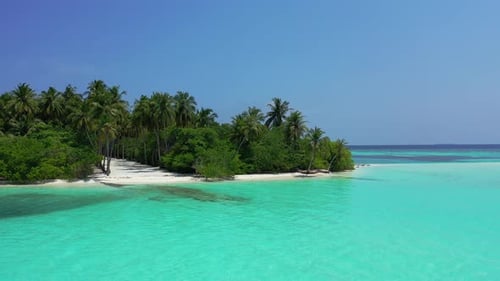 Wide angle flying abstract shot of a white paradise beach and blue ocean background in colorful 4K