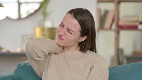 Young Woman Massages Sore Neck