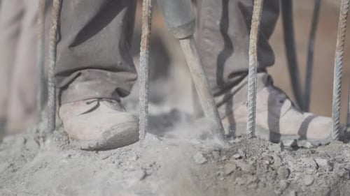 Worker Demolishing Concrete with Jackhammer