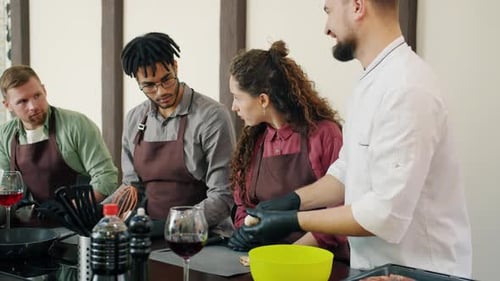 Chef Giving Cooking Class to Group of Young Adults