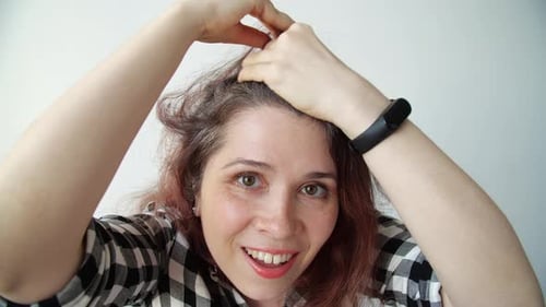 Smiling Woman Shows Gray Hair at Scalp