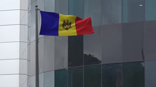 Moldova National Flag Waving in Front of Modern Building