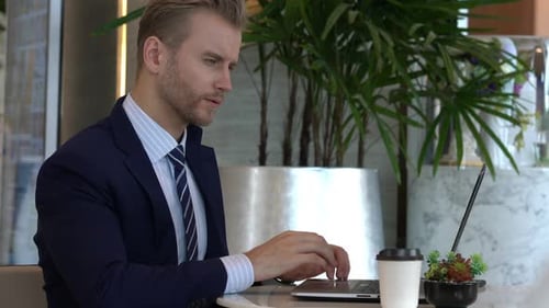 MS of businessman happiness at desk with laptop in lobby space office background