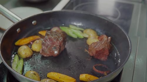 Steak and Vegetables sizzling in a hot pan