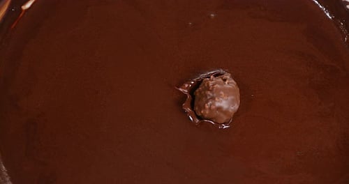 Chocolate Treat Splashes Into Melted Chocolate Bowl