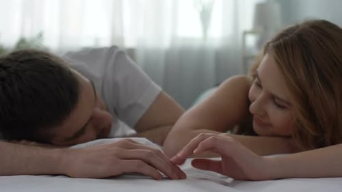 Loving Couple Cuddling in Bed Close Up