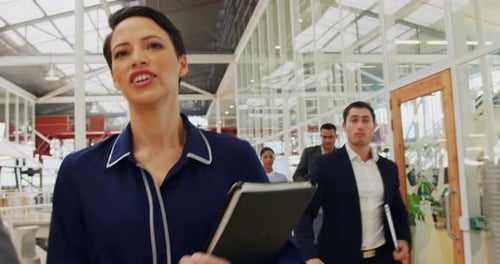 Group of Business People Walking Through Modern Office