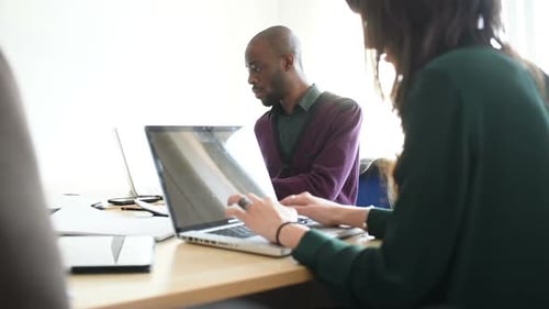 Colleagues Working Together at Office Table