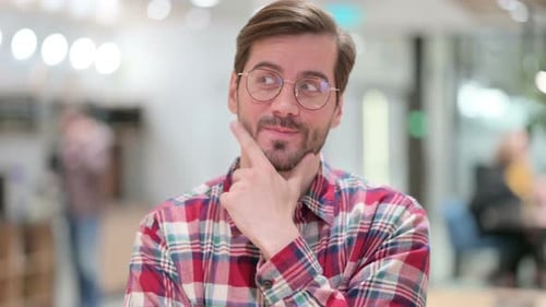 Portrait of Pensive Male Designer Thinking About Something