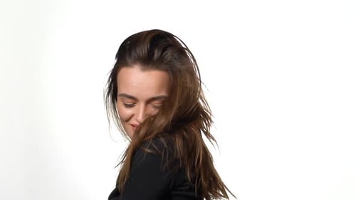 Smiling Woman Shakes Head and Tosses Hair