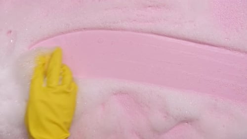 Sponge Wiping Foam from Pink Surface