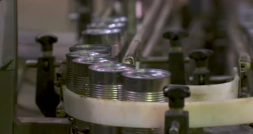 Cans Moving on Automated Conveyor Belt