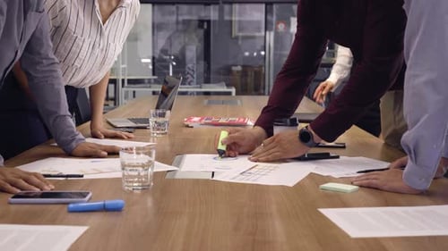 Team Discussing Charts at Office Conference Table