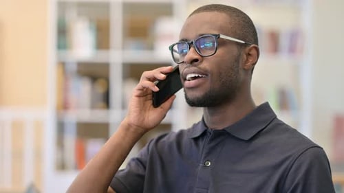 Young Adult Man Talking on Phone Indoors