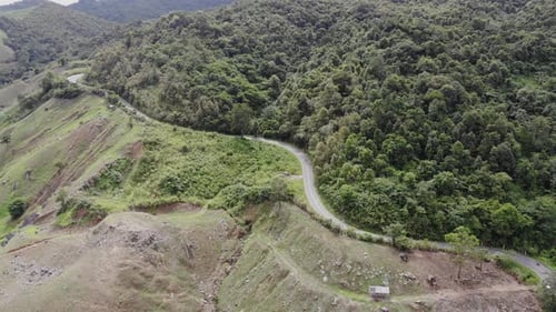 Aerial top view of sky road over top of mountain green jungle, Pua, Nan, Thailand.