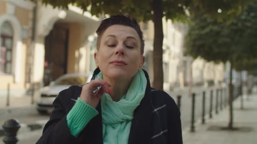 Portrait of Cheerful Middleaged Woman with Short Hair Outdoors