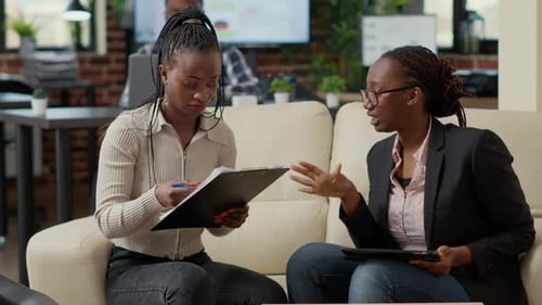 Women Discuss Deal and Shake Hands in Office