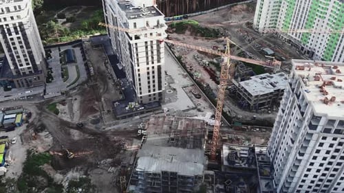 Draufsicht der Baustelle mit Kränen und unfertigen Gebäuden im Wald