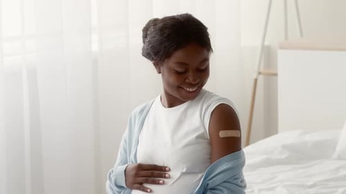 Pregnant Woman Smiling After Receiving Vaccine