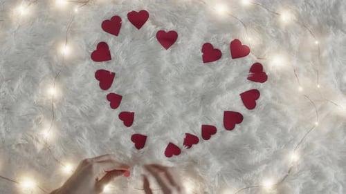 Arranging Red Hearts and Lights for Valentine's Day