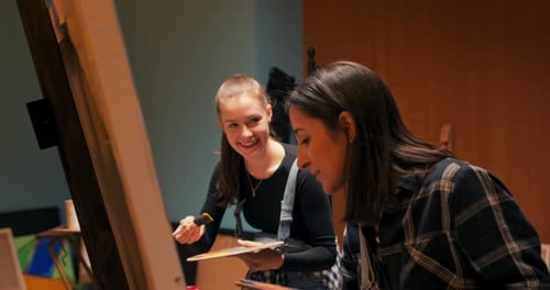 Talented Painters Painting Together a Picture From Two Sides Using Acrylic Paint Scooped From Wooden