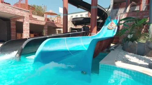Riding a Water Slide at a Tropical Waterpark