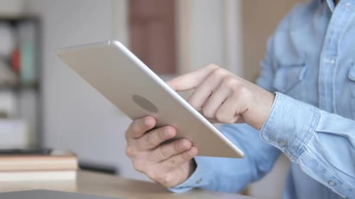 Man using tablet in home close up