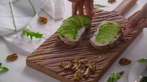 Avocado Toast on Wooden Cutting Board with Walnuts