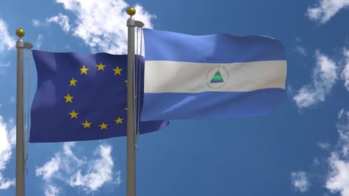 European Union and Nicaragua Flags Waving in Wind on Flagpoles