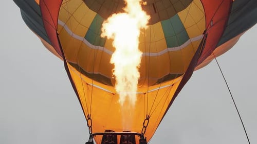 Flame filling a colorful hot air balloon