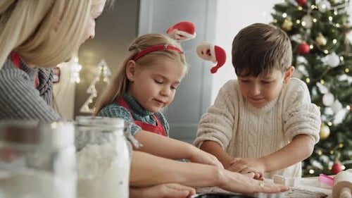 Family Making Christmas Cookies in Kitchen