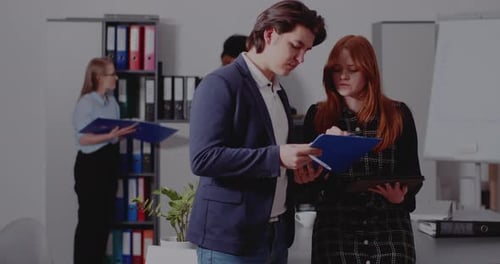 Businessman Discussing with Manager Over Document