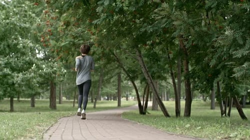 Rear View of Woman Running in Park