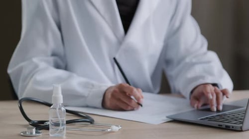 Close Up View Unknown Female Medical Health Care Worker Typing Text on Laptop Sitting at Hospital