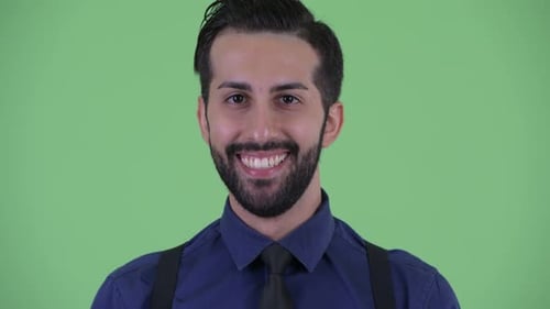 Face of Happy Young Bearded Persian Businessman Smiling
