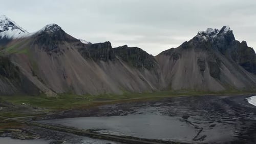 Drone Panning Over Black Sand Beach And Vestrahorn Mountain