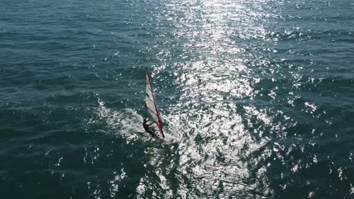 Skiing Windsurfing in the Sea at Sunset