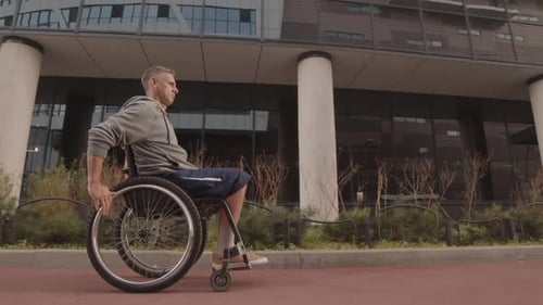 Young Man in Wheelchair on Walk